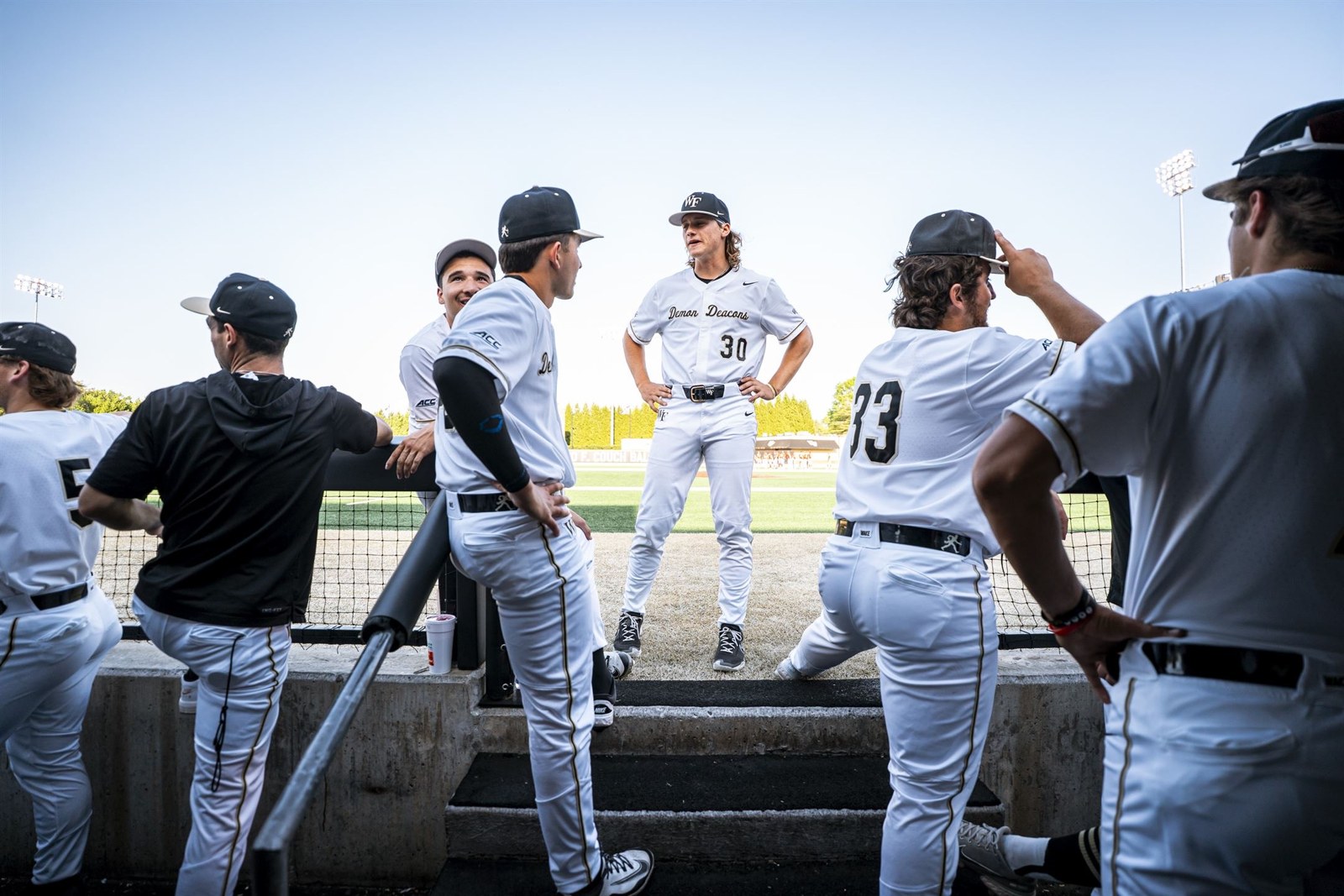Wake Forest baseball players together at the dugout